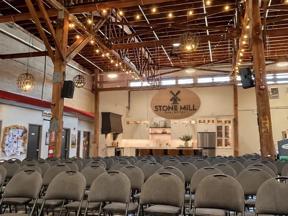 The market floor under timber beams and string lights, decorated for the holidays